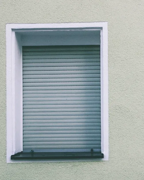 Fenêtre sur façade enduite, volet roulant fermé